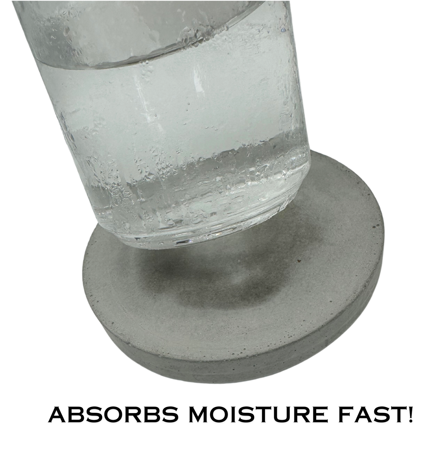 Round cement gray concrete coaster showing fast absorption of a condensation ring, highlighting its quick moisture-wicking ability.