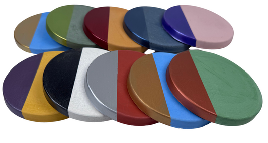Ten round concrete coasters with a painted metallic half in assorted colors, are shown in a slightly overlapping arrangement.
